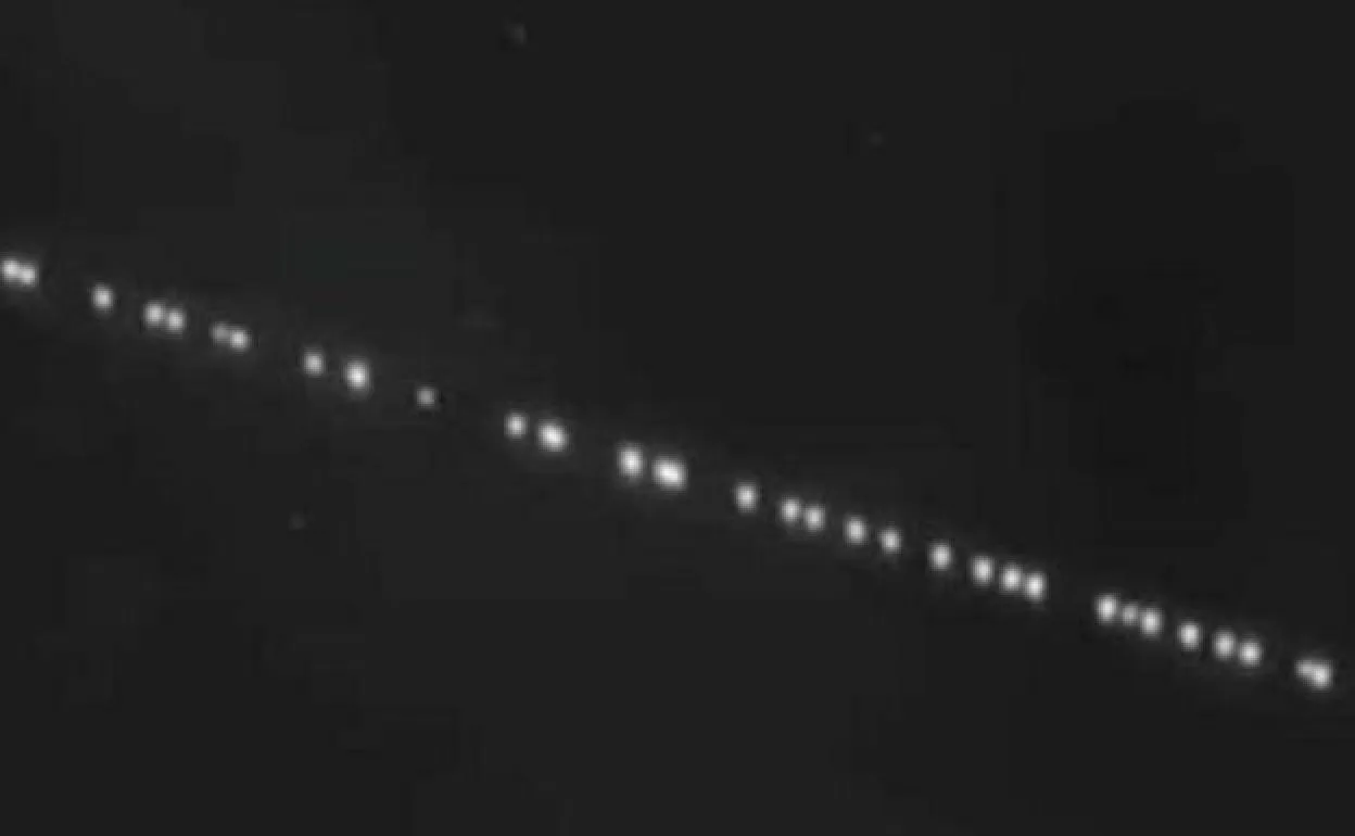 Starlink satellites the straight line of lights in the sky over Spain
